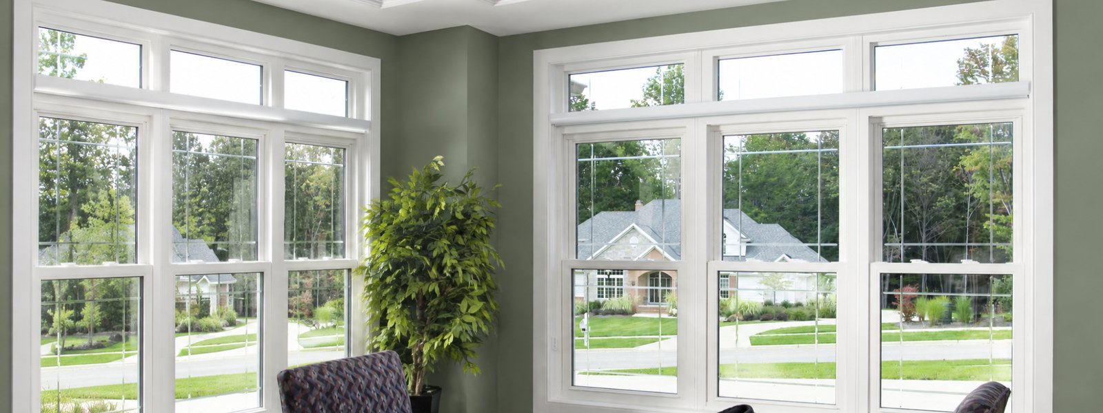 White double-hung replacement windows with transoms in a dining room corner